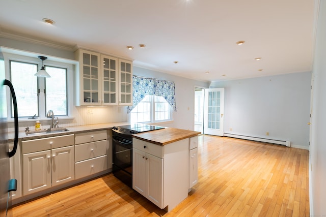 138 White Birch Dr, Guilford, CT 06437 - kitchen with a sink, a baseboard heating unit, butcher block countertops, black electric range, and crown molding