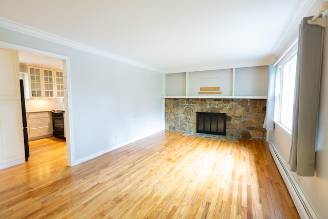 138 White Birch Dr, Guilford, CT 06437 - unfurnished living room featuring a baseboard radiator, light wood-style floors, crown molding, a fireplace, and baseboards