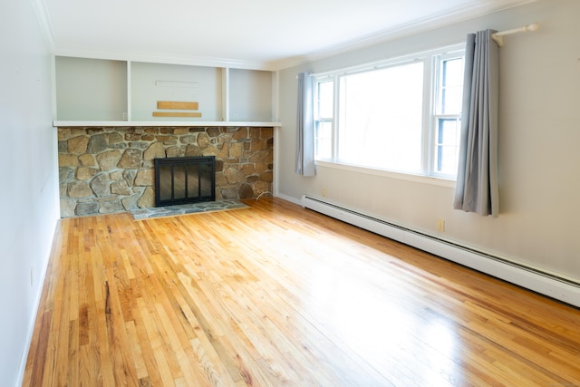 138 White Birch Dr, Guilford, CT 06437 - unfurnished living room with baseboard heating, wood finished floors, ornamental molding, and a stone fireplace