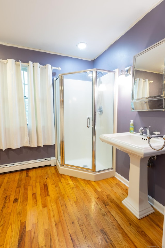 138 White Birch Dr, Guilford, CT 06437 - bathroom featuring baseboard heating, a shower stall, wood finished floors, and baseboards