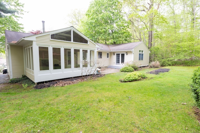 138 White Birch Dr, Guilford, CT 06437 - back of house with a sunroom, a lawn, and a shingled roof
