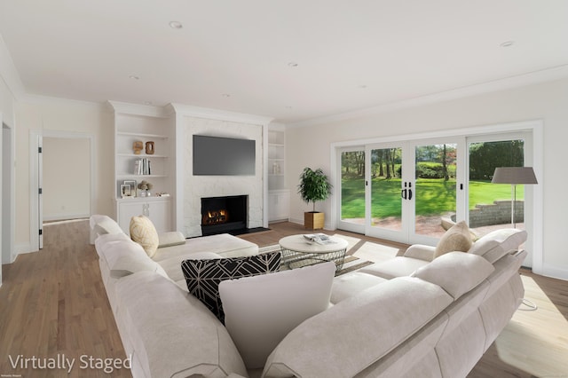 19 Stone Fence Ln, Stamford, CT 06903 - living room featuring a fireplace, light wood-style flooring, built in features, baseboards, and ornamental molding