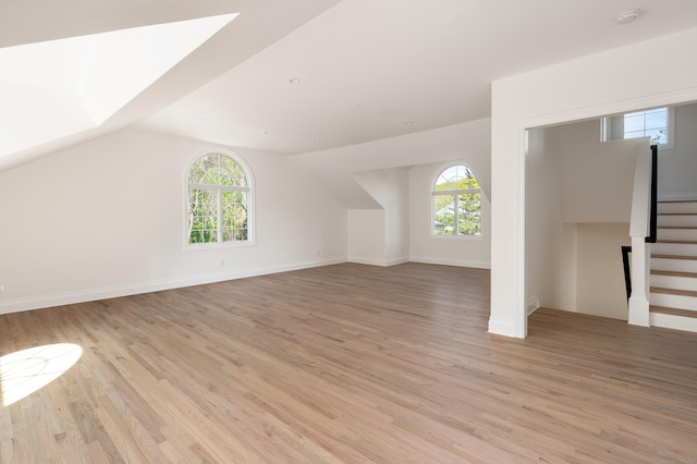 19 Stone Fence Ln, Stamford, CT 06903 - additional living space with plenty of natural light, light wood-style floors, stairway, vaulted ceiling, and baseboards