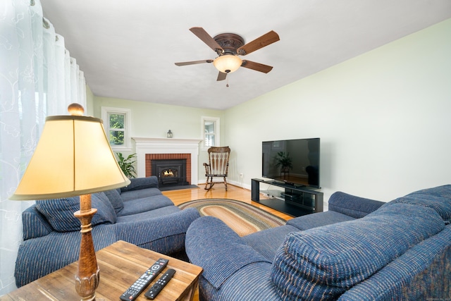 995 Maple St, Wethersfield, CT 06109 - living room featuring wood finished floors, a ceiling fan, a brick fireplace, and baseboards