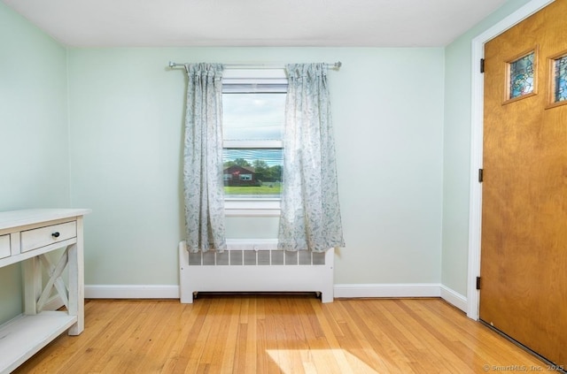 995 Maple St, Wethersfield, CT 06109 - empty room featuring radiator, light wood finished floors, and baseboards