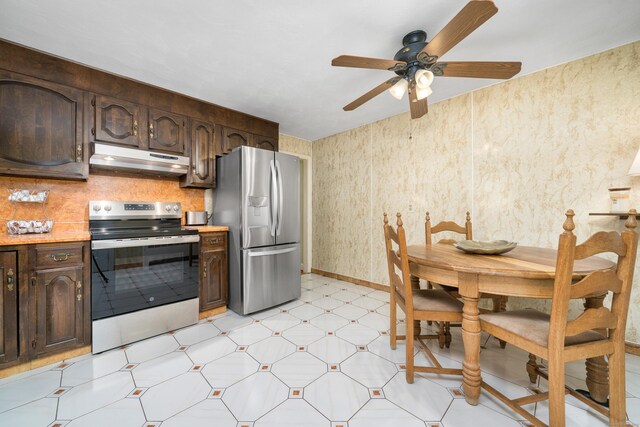 995 Maple St, Wethersfield, CT 06109 - kitchen featuring stainless steel appliances, under cabinet range hood, light flooring, dark brown cabinets, and light countertops
