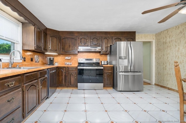 995 Maple St, Wethersfield, CT 06109 - kitchen featuring stainless steel appliances, a sink, under cabinet range hood, light floors, and a ceiling fan