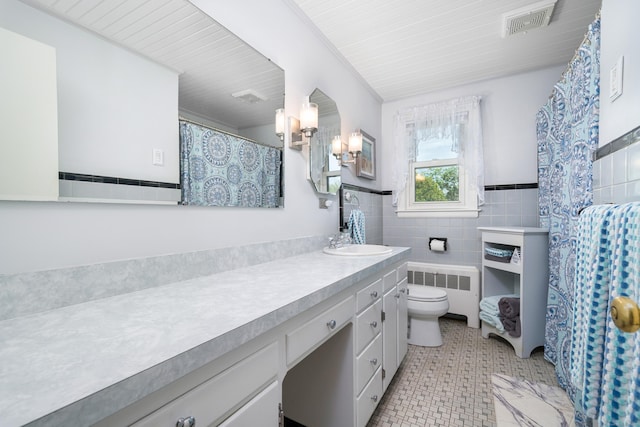 995 Maple St, Wethersfield, CT 06109 - full bath featuring radiator, vanity, tile walls, toilet, and tile patterned flooring