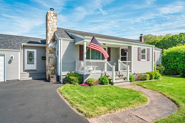 995 Maple St, Wethersfield, CT 06109 - view of front of house featuring covered porch, a chimney, and a front yard