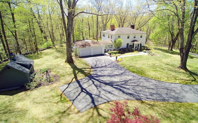 28 Wayside Ln, Redding, CT 06896 - view of grassy yard with driveway, a forest view, and an attached garage