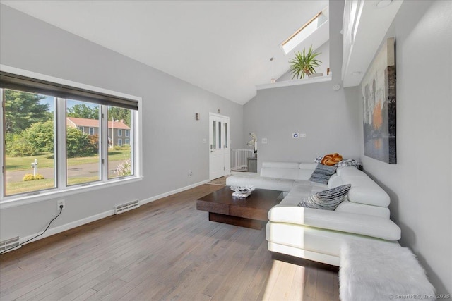 living room with lofted ceiling, wood finished floors, and baseboards