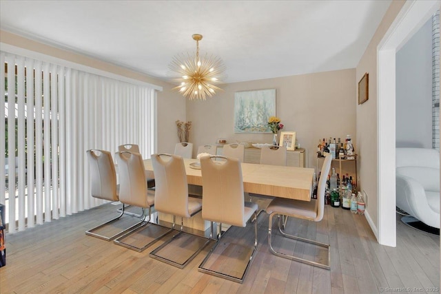 dining space with a chandelier and hardwood / wood-style floors