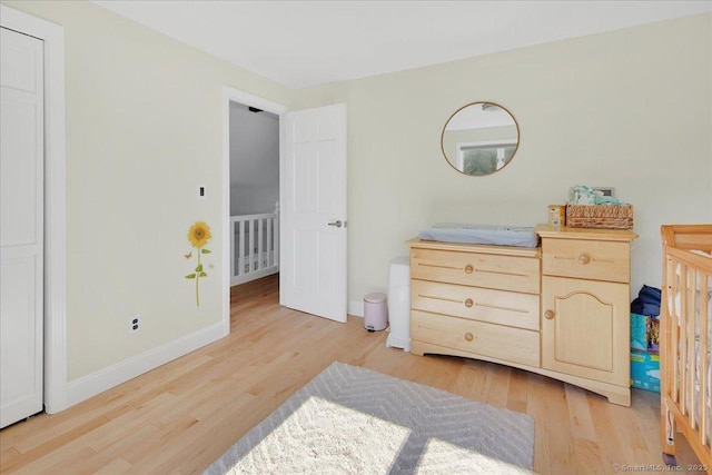 bedroom featuring light wood-type flooring and baseboards