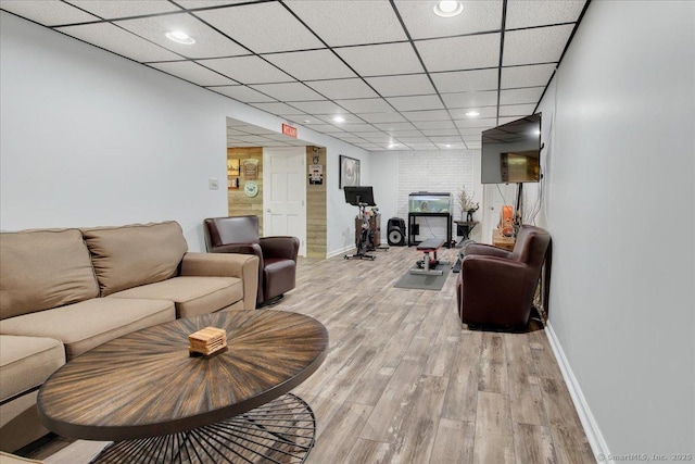 living area featuring baseboards, light wood-type flooring, and recessed lighting