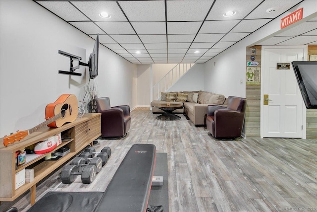 workout area featuring wood finished floors, baseboards, and recessed lighting