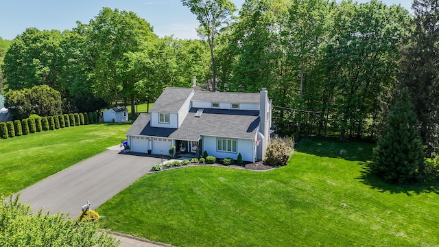 14 Stakey Farm Rd, Southington, CT 06489 - view of front of property with asphalt driveway, a front lawn, a garage, and a chimney