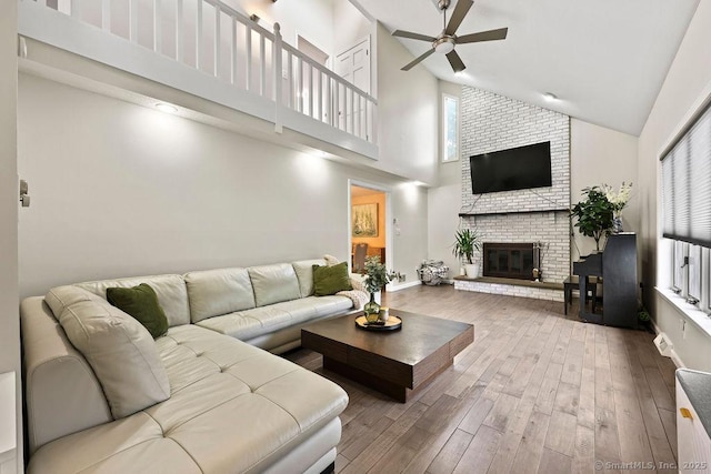14 Stakey Farm Rd, Southington, CT 06489 - living area featuring high vaulted ceiling, ceiling fan, wood finished floors, a brick fireplace, and baseboards