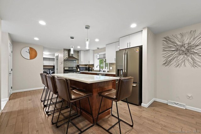 14 Stakey Farm Rd, Southington, CT 06489 - kitchen featuring stainless steel appliances, wall chimney range hood, baseboards, light countertops, and recessed lighting