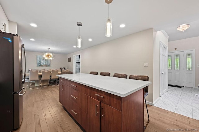 14 Stakey Farm Rd, Southington, CT 06489 - kitchen featuring freestanding refrigerator, a kitchen island, a kitchen breakfast bar, light countertops, and recessed lighting