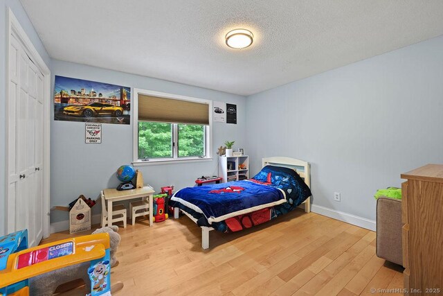 14 Stakey Farm Rd, Southington, CT 06489 - bedroom with wood finished floors, a textured ceiling, and baseboards