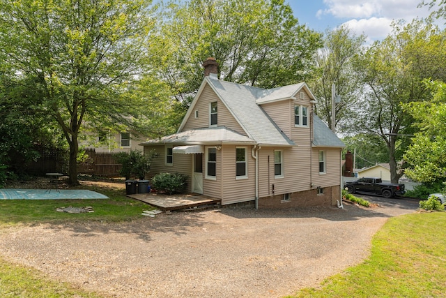 9 Florence St, East Haven, CT 06513 - view of front of home with a chimney, a shingled roof, and a wooden deck