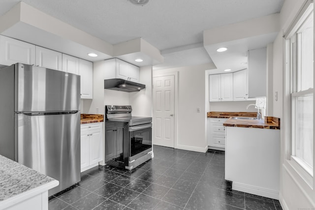 9 Florence St, East Haven, CT 06513 - kitchen featuring stainless steel appliances, under cabinet range hood, a sink, white cabinets, and recessed lighting