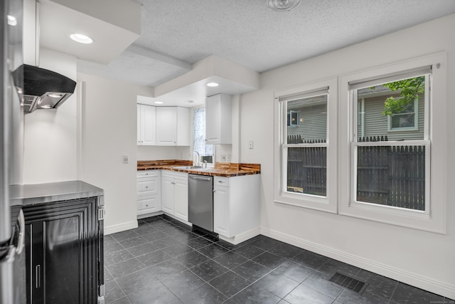 9 Florence St, East Haven, CT 06513 - kitchen featuring dishwasher, baseboards, white cabinets, a textured ceiling, and dark tile patterned flooring