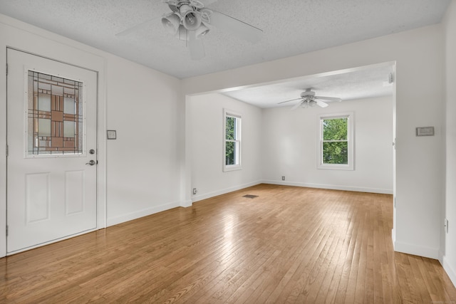 9 Florence St, East Haven, CT 06513 - unfurnished room featuring ceiling fan, light wood-style flooring, a textured ceiling, and baseboards