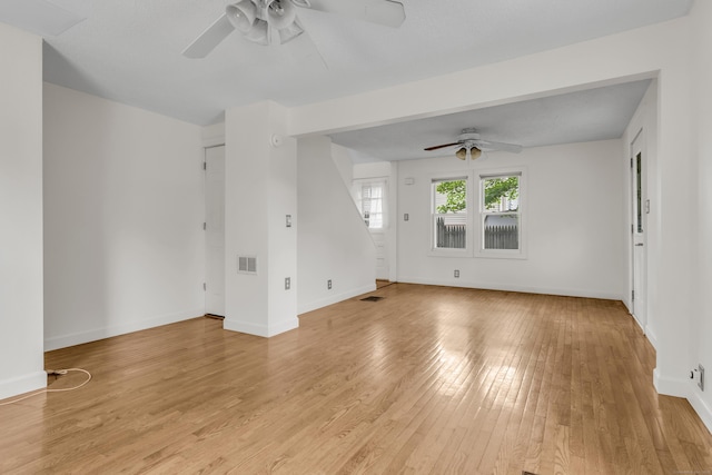 9 Florence St, East Haven, CT 06513 - unfurnished living room featuring a ceiling fan, light wood finished floors, and baseboards