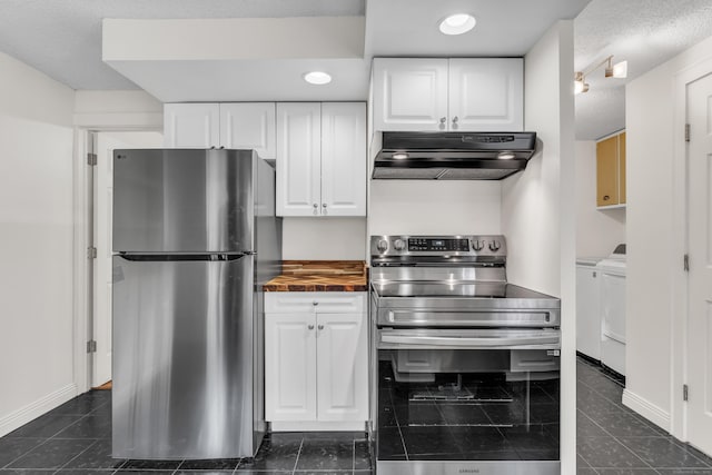 9 Florence St, East Haven, CT 06513 - kitchen with stainless steel appliances, under cabinet range hood, separate washer and dryer, white cabinetry, and wooden counters