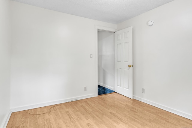9 Florence St, East Haven, CT 06513 - unfurnished room featuring wood finished floors, baseboards, a smoke detector, and a textured ceiling