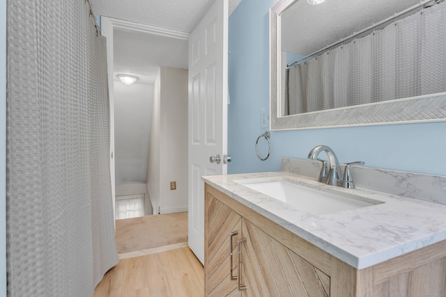 9 Florence St, East Haven, CT 06513 - bathroom featuring wood finished floors, vanity, and a textured ceiling