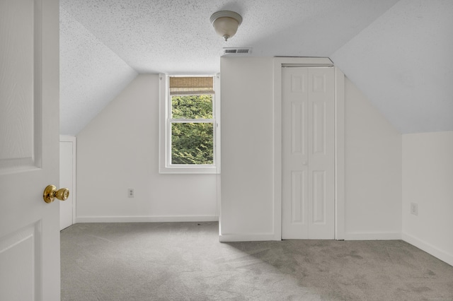 9 Florence St, East Haven, CT 06513 - bonus room with vaulted ceiling, carpet floors, a textured ceiling, and baseboards