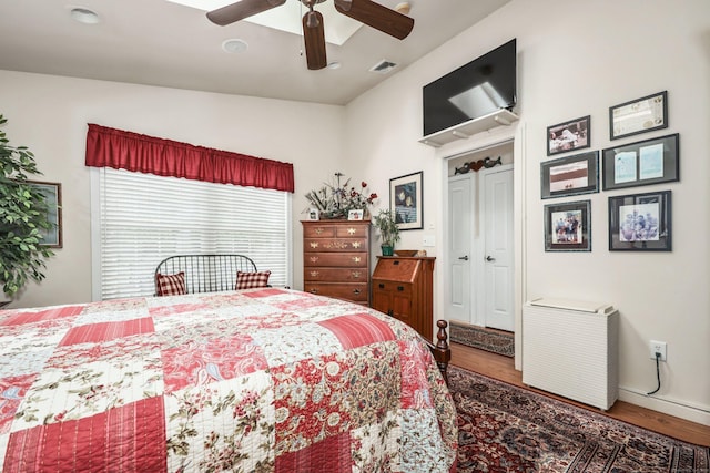 bedroom with wood finished floors, baseboards, ceiling fan, and vaulted ceiling