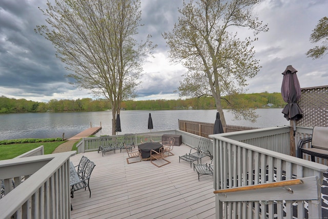 wooden deck featuring a water view