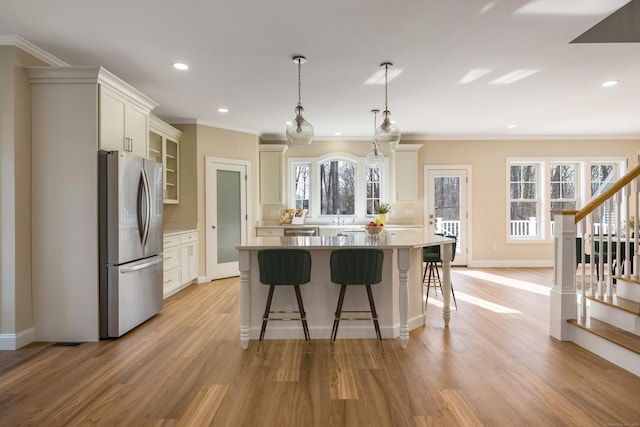 40 Allyn St, Groton, CT 06355 - kitchen featuring stainless steel appliances, a kitchen bar, light wood-type flooring, glass insert cabinets, and a center island