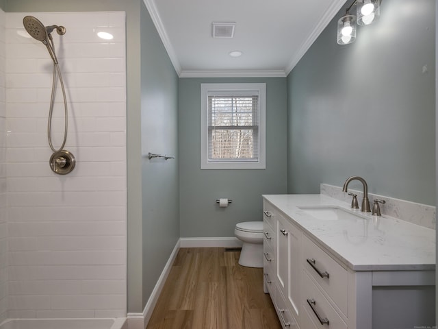 40 Allyn St, Groton, CT 06355 - bathroom with tiled shower, ornamental molding, wood finished floors, vanity, and toilet