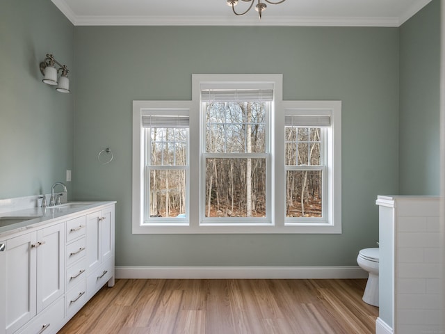 40 Allyn St, Groton, CT 06355 - bathroom with wood finished floors, baseboards, crown molding, toilet, and double vanity