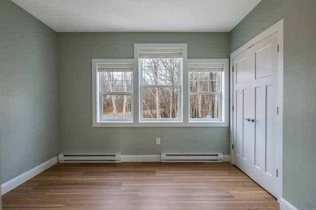40 Allyn St, Groton, CT 06355 - unfurnished bedroom with baseboard heating, light wood-style flooring, and baseboards