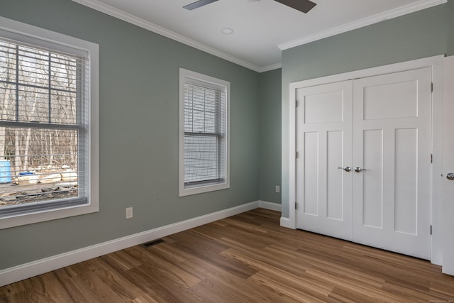 40 Allyn St, Groton, CT 06355 - unfurnished bedroom featuring crown molding, wood finished floors, baseboards, ceiling fan, and a closet