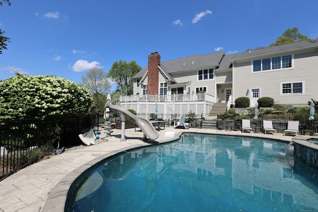 110 Nursery Rd, Ridgefield, CT 06877 - view of swimming pool featuring a water slide, fence, stairs, a patio area, and a pool with connected hot tub