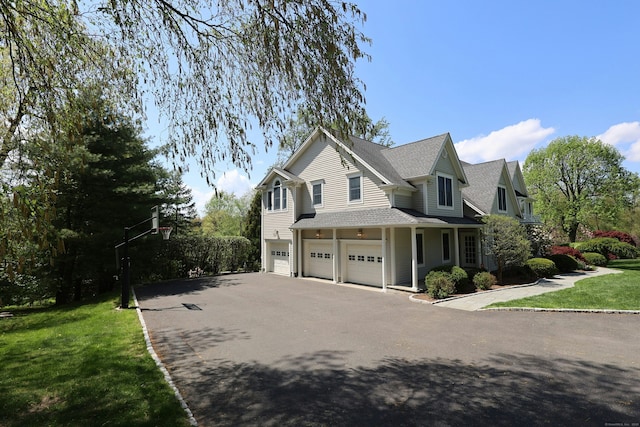 110 Nursery Rd, Ridgefield, CT 06877 - view of home's exterior featuring a garage, driveway, a lawn, and a shingled roof