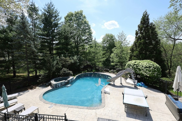 110 Nursery Rd, Ridgefield, CT 06877 - view of swimming pool with a patio area, fence, a water slide, and a pool with connected hot tub