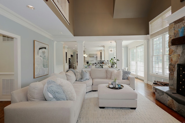 110 Nursery Rd, Ridgefield, CT 06877 - living room featuring decorative columns, wood finished floors, ornamental molding, and a high ceiling
