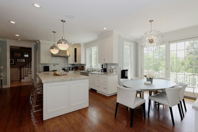 110 Nursery Rd, Ridgefield, CT 06877 - kitchen featuring light countertops, ornamental molding, dishwasher, dark wood-style flooring, and pendant lighting