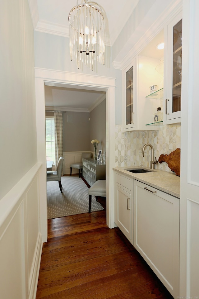 110 Nursery Rd, Ridgefield, CT 06877 - bar area featuring ornamental molding, a sink, a chandelier, dark wood finished floors, and a decorative wall