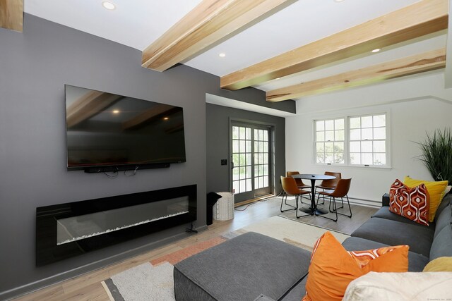 110 Nursery Rd, Ridgefield, CT 06877 - living room with beamed ceiling, a glass covered fireplace, recessed lighting, and wood finished floors