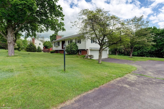 21 Summit Farms Rd, Southington, CT 06489 - raised ranch featuring driveway, a chimney, a front yard, and a garage