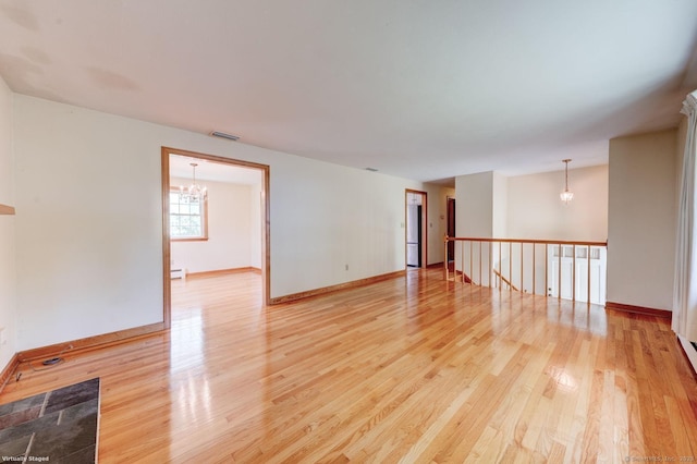 21 Summit Farms Rd, Southington, CT 06489 - spare room with a chandelier, light wood-style flooring, baseboard heating, and baseboards