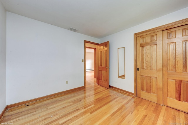 21 Summit Farms Rd, Southington, CT 06489 - unfurnished bedroom featuring light wood-style flooring, baseboards, a baseboard radiator, and a closet